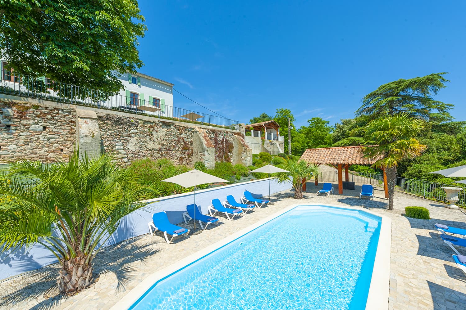 Private pool and sun loungers at Domaine de Nérige